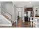 Entryway and Hallway with dark wood floors, a stairwell, and stainless steel appliances at 3224 Wishing Well Wynd, Apex, NC 27502