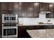 The kitchen features built-in stainless appliances and granite countertops with modern cabinetry at 3224 Wishing Well Wynd, Apex, NC 27502