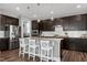 The kitchen features stainless steel appliances and granite countertops with modern cabinetry at 3224 Wishing Well Wynd, Apex, NC 27502