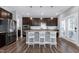 Bright kitchen with stainless steel appliances, a large island, and dark cabinets, perfect for cooking at 3224 Wishing Well Wynd, Apex, NC 27502