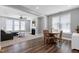Open-concept living room featuring a fireplace, plush sofa, and round dining table with natural light at 3224 Wishing Well Wynd, Apex, NC 27502