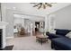 Inviting living space with wood floors, fireplace, sofa, and view of the kitchen and dining areas at 3224 Wishing Well Wynd, Apex, NC 27502
