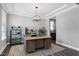 Well-lit home office with a large desk, stylish decor, and neutral color palette at 3224 Wishing Well Wynd, Apex, NC 27502