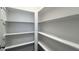 Bright pantry featuring ample shelving space for organized storage and attractive wood-look flooring at 3224 Wishing Well Wynd, Apex, NC 27502