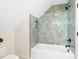 Bathroom features a tub with tiled shower and sleek black hardware at 3281 Phillips Chapel Rd, Haw River, NC 27258