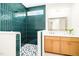 Stylish bathroom features green tiled shower, glass partition, and modern vanity with a beautiful mirror at 3281 Phillips Chapel Rd, Haw River, NC 27258