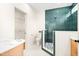 Stylish bathroom featuring a walk-in shower with green tile, modern fixtures, and a walk-in closet at 3281 Phillips Chapel Rd, Haw River, NC 27258