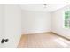 Bright bedroom featuring light wood flooring, white walls, and a large window at 3281 Phillips Chapel Rd, Haw River, NC 27258
