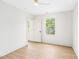 Bright bedroom featuring light wood flooring, white walls, and a large window at 3281 Phillips Chapel Rd, Haw River, NC 27258