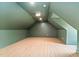 Large bonus room with angled ceilings and modern lighting at 3281 Phillips Chapel Rd, Haw River, NC 27258