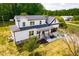 Overhead view of a two story home with a white exterior, black roof, and covered front porch at 3281 Phillips Chapel Rd, Haw River, NC 27258