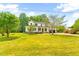 Exterior view of a newly constructed farmhouse-style home on a large lot at 3281 Phillips Chapel Rd, Haw River, NC 27258