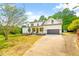 Two story farmhouse-style home with covered porch and attached garage at 3281 Phillips Chapel Rd, Haw River, NC 27258