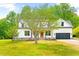 Exterior view of a farmhouse-style home with a well-manicured lawn at 3281 Phillips Chapel Rd, Haw River, NC 27258