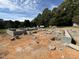 New home foundation with cinder blocks in a beautiful rural neighborhood under a partly cloudy sky at 3281 Phillips Chapel Rd, Haw River, NC 27258
