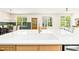 Bright, open-concept living space with a kitchen island and a view to the dining area and backyard at 3281 Phillips Chapel Rd, Haw River, NC 27258
