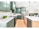Modern kitchen with stylish green cabinets, stainless steel appliances, and a bright white countertop island at 3281 Phillips Chapel Rd, Haw River, NC 27258