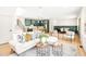 Bright living room with a cozy sofa, stylish chairs, light wood flooring, and an open dining area at 3281 Phillips Chapel Rd, Haw River, NC 27258