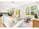 Inviting living room with large windows, neutral decor, and a seamless flow to the dining area at 3281 Phillips Chapel Rd, Haw River, NC 27258