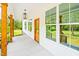Close-up of the porch showcasing the architectural details and natural light pouring in from the large windows at 3281 Phillips Chapel Rd, Haw River, NC 27258