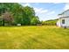 Lush yard with mature trees surrounding home, creating a serene and private setting at 3281 Phillips Chapel Rd, Haw River, NC 27258