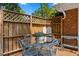 This deck features a dining set, privacy fence, and stylish lanterns at 3425 Brentwood Rd, Raleigh, NC 27604