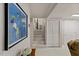 Basement hallway with artwork leads to carpeted stairs, blending functionality with an artistic touch at 3425 Brentwood Rd, Raleigh, NC 27604
