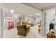 Inviting basement features a seating area, neutral decor, and a glimpse into an adjacent utility space at 3425 Brentwood Rd, Raleigh, NC 27604