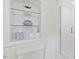 This bathroom includes a toilet and shelving with decorative elements and necessities at 3425 Brentwood Rd, Raleigh, NC 27604