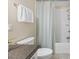 Bathroom features a shower with curtain, toilet, towel rack, and dark granite countertop at 3425 Brentwood Rd, Raleigh, NC 27604