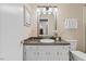 Bathroom featuring a vanity, sink, and a well-lit mirror with stylish fixtures at 3425 Brentwood Rd, Raleigh, NC 27604
