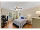 Cozy bedroom featuring hardwood floors, a ceiling fan, and a comfortable bed at 3425 Brentwood Rd, Raleigh, NC 27604