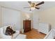 Comfortable Bedroom with a crib, changing table, soft chair, and a ceiling fan at 3425 Brentwood Rd, Raleigh, NC 27604
