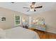 Bright bedroom featuring hardwood floors, a ceiling fan, and neutral decor at 3425 Brentwood Rd, Raleigh, NC 27604