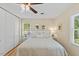 This bedroom offers hardwood floors, a ceiling fan, natural light and ample closet space at 3425 Brentwood Rd, Raleigh, NC 27604