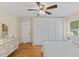 Bright bedroom with wood floors, ceiling fan, and large closet for ample storage at 3425 Brentwood Rd, Raleigh, NC 27604