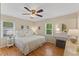 Bedroom showcasing hardwood floors, natural light, and ceiling fan at 3425 Brentwood Rd, Raleigh, NC 27604