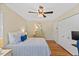 Bright bedroom featuring hardwood floors, a ceiling fan, and a well-lit seating area at 3425 Brentwood Rd, Raleigh, NC 27604