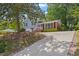 An exterior elevation view showcasing the home's well-kept lawn, driveway, and curb appeal at 3425 Brentwood Rd, Raleigh, NC 27604