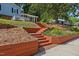 Beautifully landscaped front yard with tiered retaining walls and steps leading to the home at 3425 Brentwood Rd, Raleigh, NC 27604