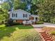 Charming two-story home with a manicured lawn, brick accents, and inviting front porch at 3425 Brentwood Rd, Raleigh, NC 27604