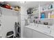 Well-organized laundry room with ample shelving for supplies and a modern washer and dryer setup at 3425 Brentwood Rd, Raleigh, NC 27604