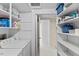 Bright laundry room with organized shelves, providing efficient space for cleaning and storage solutions at 3425 Brentwood Rd, Raleigh, NC 27604