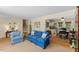 Bright living room with ample seating, a neutral rug, and a view into the breakfast area at 3425 Brentwood Rd, Raleigh, NC 27604