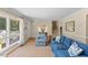 Spacious living room featuring comfortable seating, and natural light from the large windows at 3425 Brentwood Rd, Raleigh, NC 27604