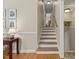 The staircase features wood steps and railings, leading to the upper level of the home at 3425 Brentwood Rd, Raleigh, NC 27604