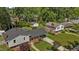 Aerial view of the home and the surrounding neighborhood with mature trees and green lawns at 3501 Arrowwood Dr, Raleigh, NC 27604