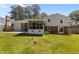 Backyard of this home featuring a screened in porch, mature lawn and patio at 3501 Arrowwood Dr, Raleigh, NC 27604