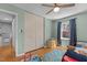 This bedroom has pale green walls, wood floors, a ceiling fan and a large closet at 3501 Arrowwood Dr, Raleigh, NC 27604