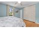 This cozy bedroom has hardwood floors, a ceiling fan and two windows for a light-filled, relaxing space at 3501 Arrowwood Dr, Raleigh, NC 27604
